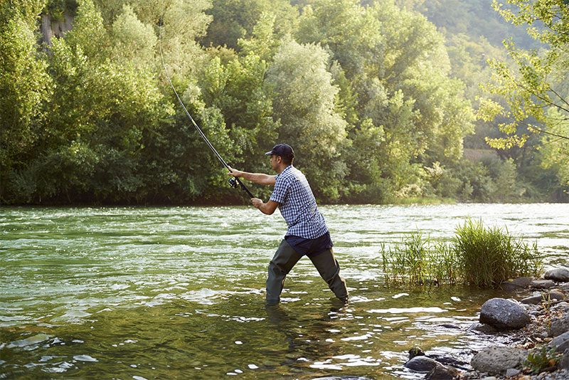 fisherman in stream