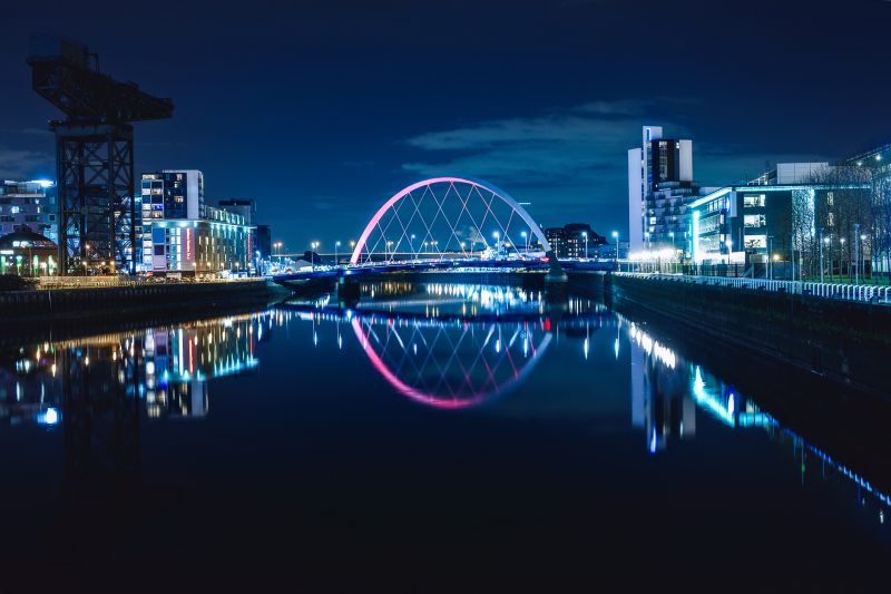 Night view of the Clyde Arc or Squinty Bridge from the East and river Clyde, Glasgow, Scotland